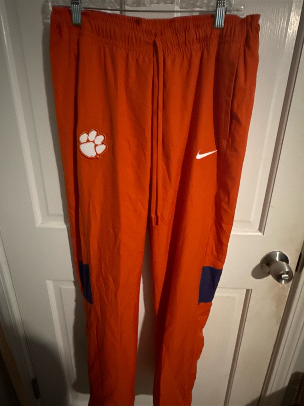 Nike Orange Track Pants with White Swoosh and Paw Patch